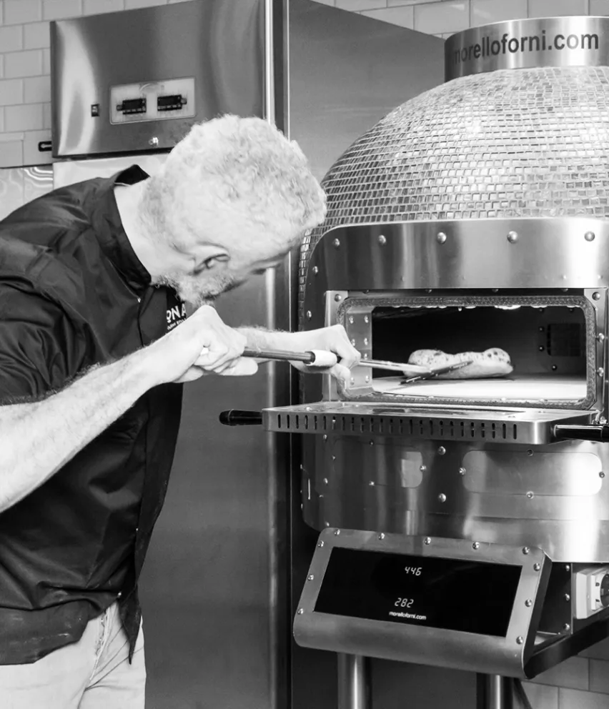 pizza going into the pizza oven at sonata pizza school workshop